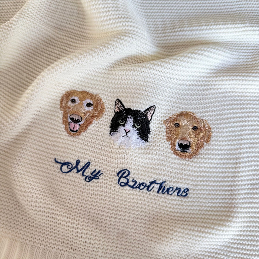 Cream knitted blanket with three embroidered pet portraits