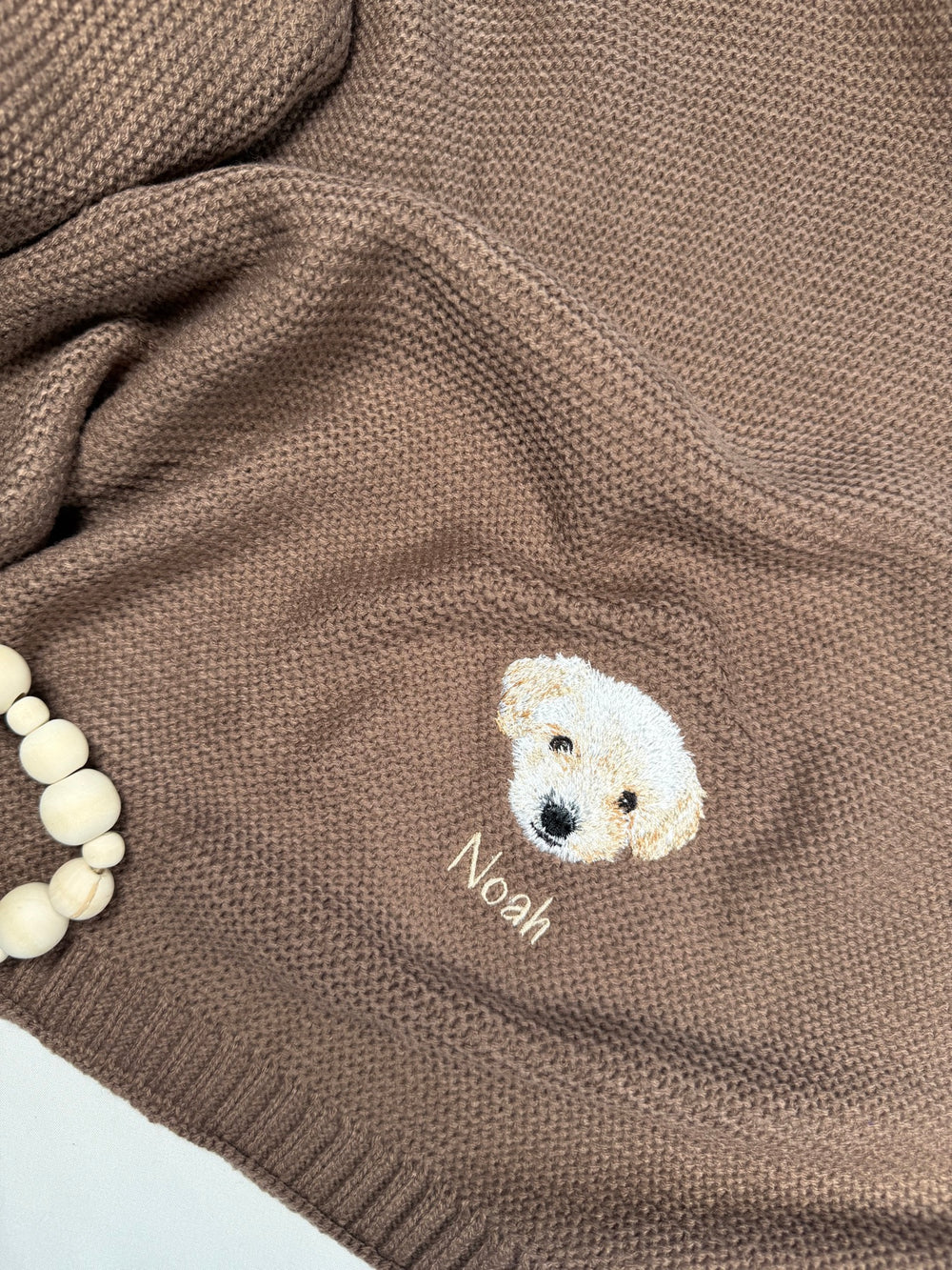 Brown knitted blanket with embroidered puppy portrait and name Noah