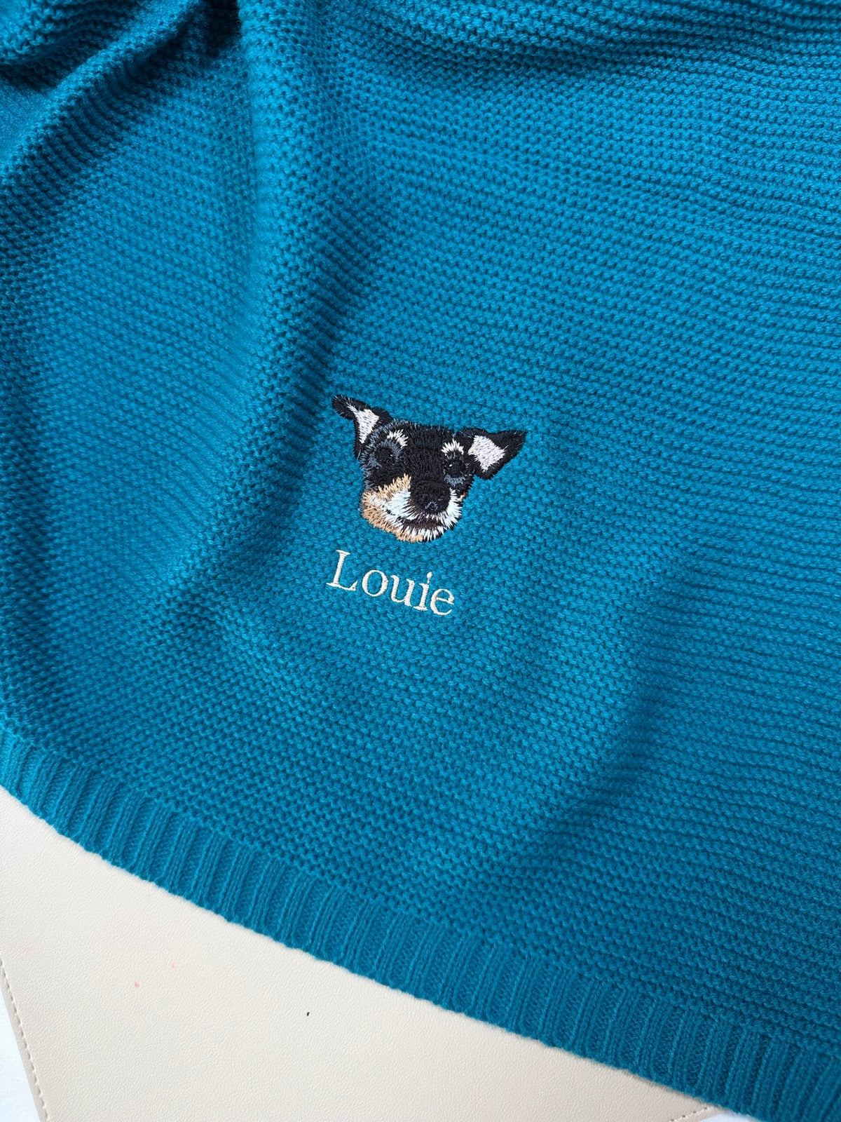 Teal knitted blanket with embroidered dog portrait and name Louie