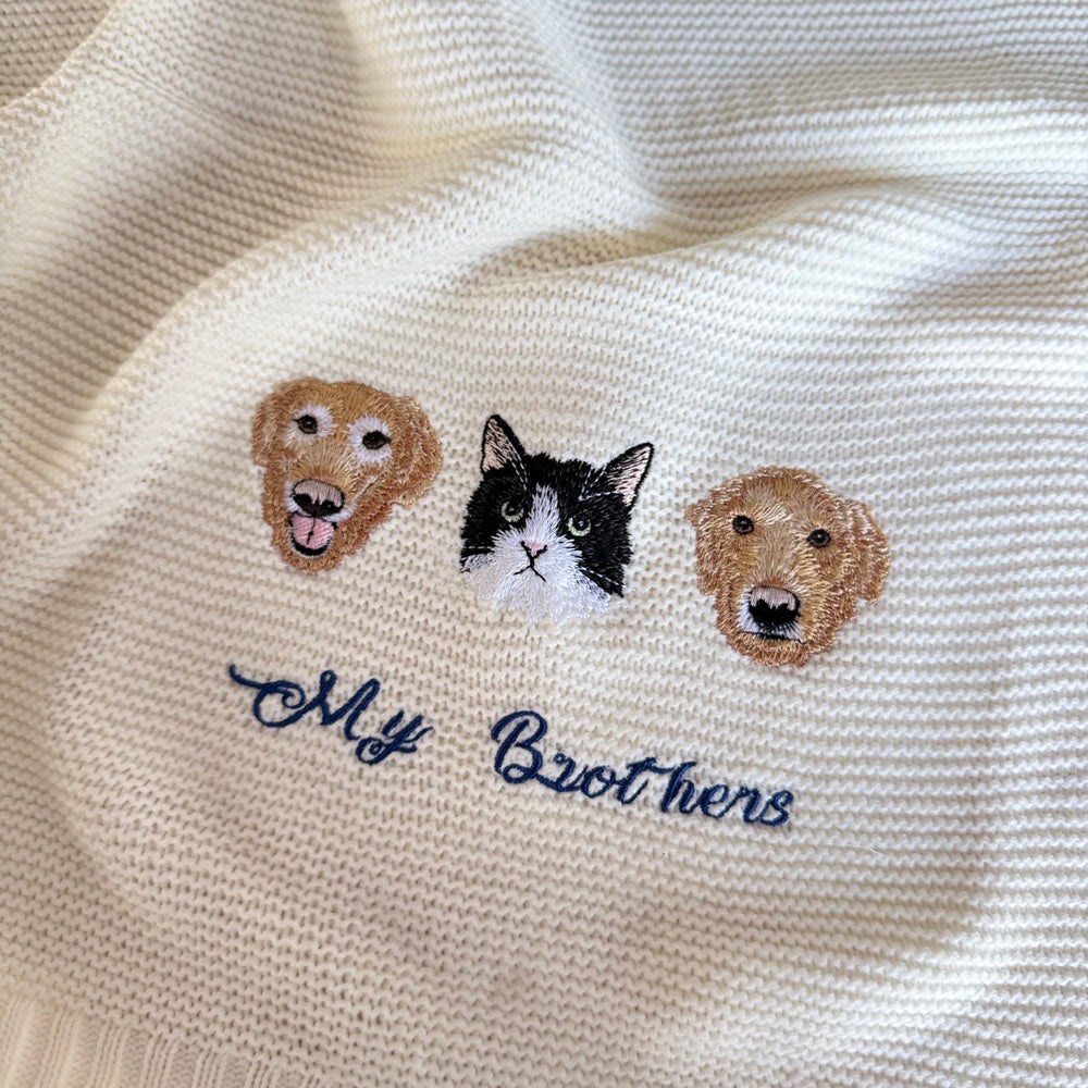 Cream knitted blanket with three embroidered pet portraits