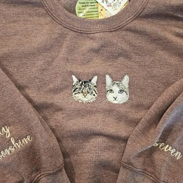 Close view of two cats embroidered in real thread